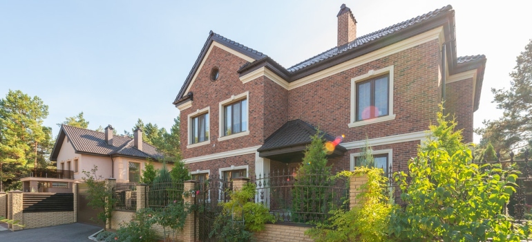 An old style brick house with the iron fence.