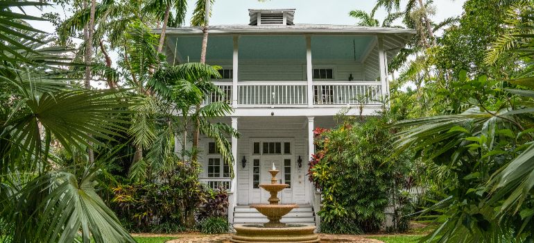 white home with plants for improving your curb appeal