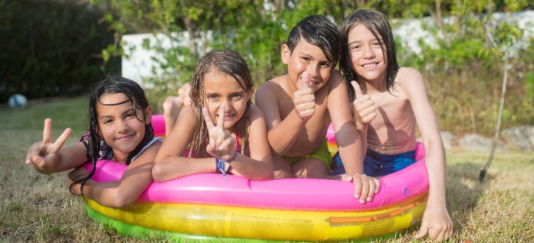 four kids in a pool