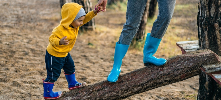 mother and son enjoying a fun time after building a low-maintenance playground in your backyard