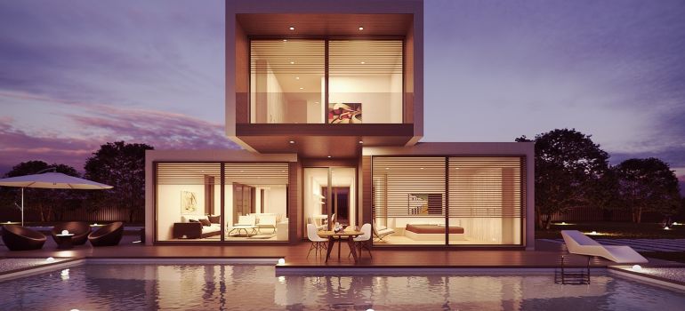 The exterior of a house with a pool.
