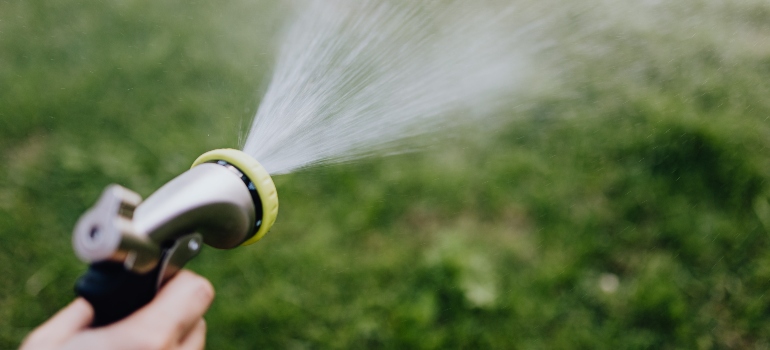 a man with a hose preparing for cleaning your patio with a pressure washer